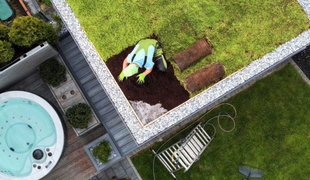 Caucasian Gardener Taking Care of a Mature Living Roof
