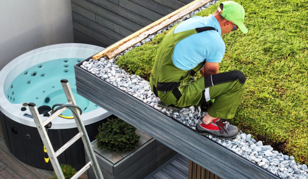 Caucasian Gardener Taking Care of a Mature Living Roof